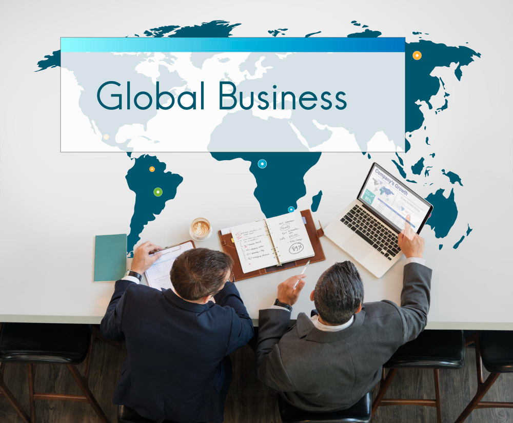 Two business professionals discussing global growth strategies with digital technology, symbolizing the expectation for brands to use technology ethically in the global marketplace.